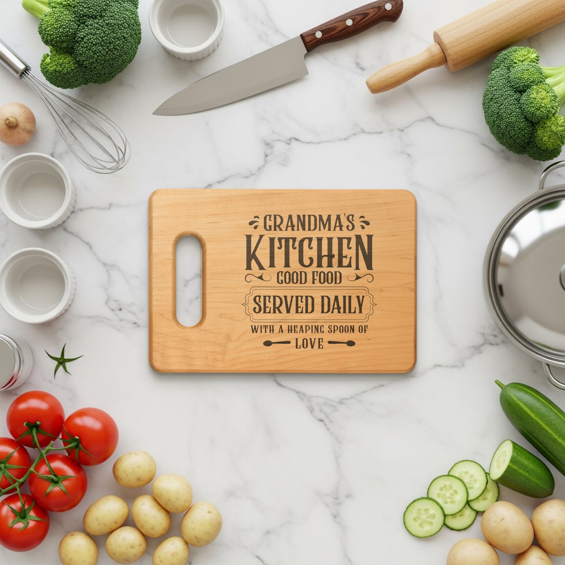 Wooden cutting board with "Grandma's Kitchen" engraving surrounded by fresh ingredients.