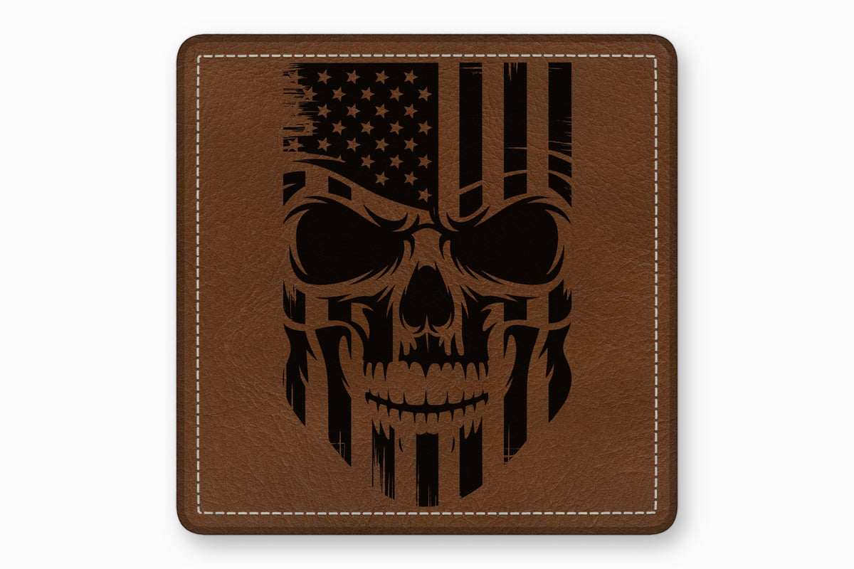Brown leather square patch with white stitched border featuring a black engraved American flag skull design.