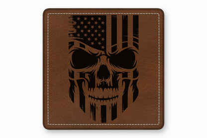 Brown leather square patch with white stitched border featuring a black engraved American flag skull design.