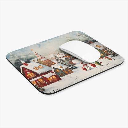 Mousepad with painted winter village scene featuring snow-covered houses and people.