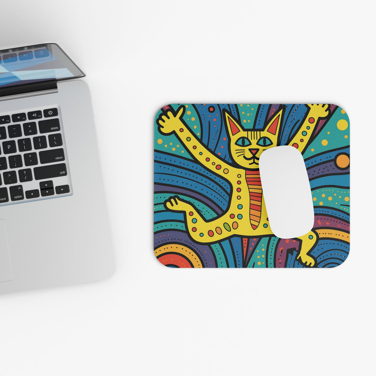 A colorful, patterned mousepad featuring a stylized yellow cat with raised paws next to a laptop.