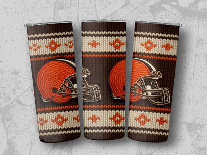 Browns helmet on a brown, cream, and orange knitted pattern tumbler.