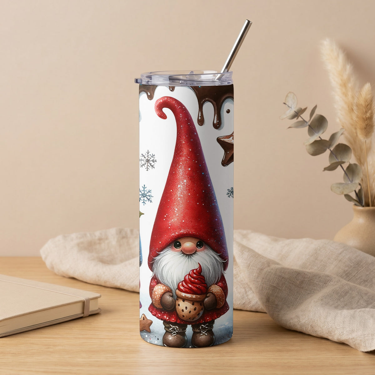 White tumbler with a gnome holding a cookie and frosting, surrounded by snowflakes and chocolate drips.
