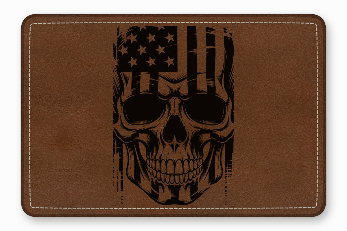 Brown leather rectangular patch with white stitched border and a black laser-engraved American flag skull design.