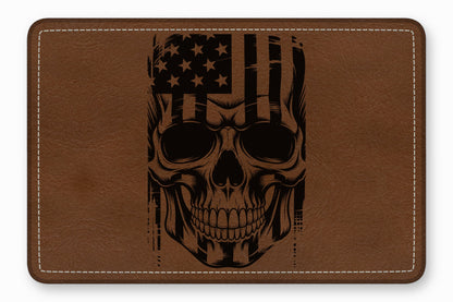 Brown leather rectangular patch with white stitched border and a black laser-engraved American flag skull design.