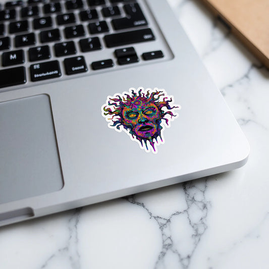 Colorful, psychedelic melting sun face sticker on a laptop.