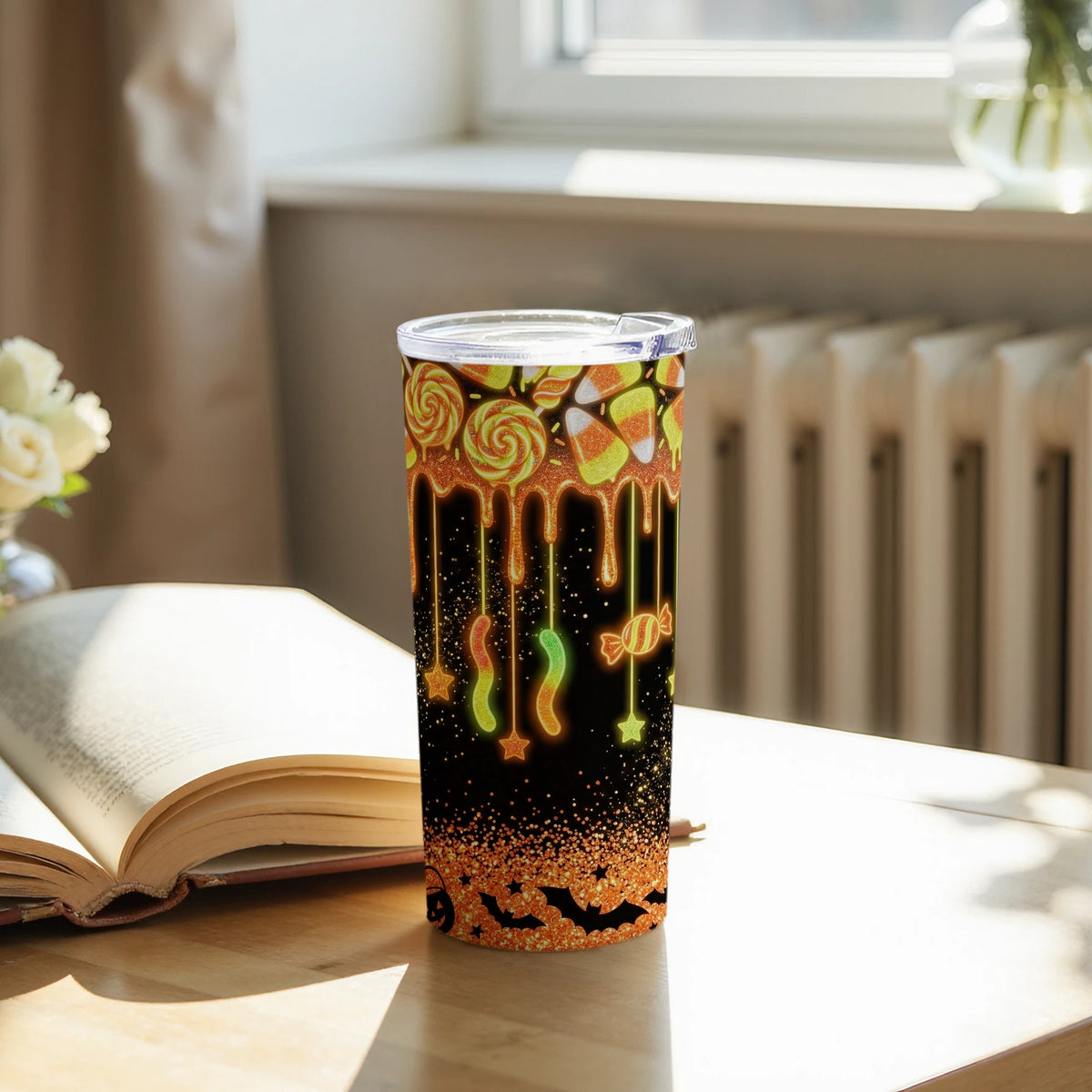 Tumbler with Halloween candy pattern, dripping glaze, bats, and glitter.