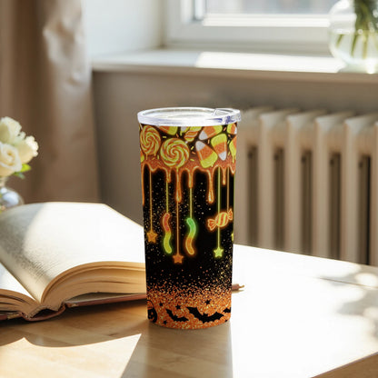 Tumbler with Halloween candy pattern, dripping glaze, bats, and glitter.