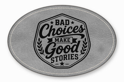 Gray leather oval patch featuring stitched borders and black text reading Bad Choices Make Good Stories.