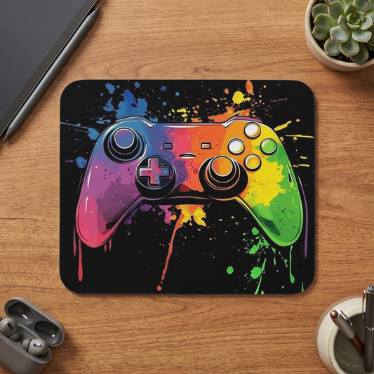 Video game controller with rainbow paint splatter on black background.