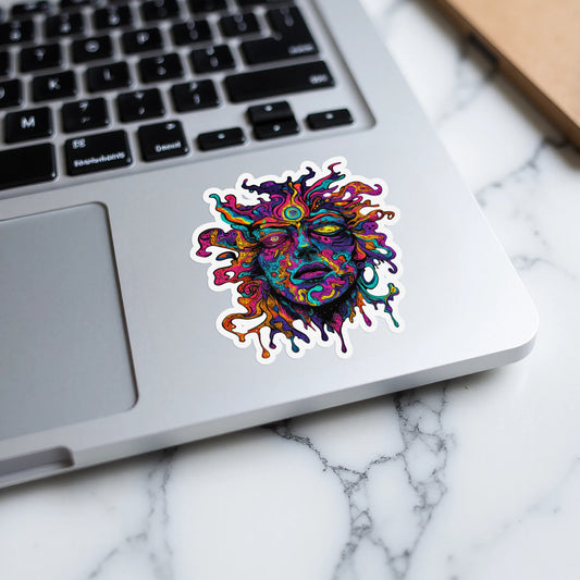 Psychedelic melting face sticker on a laptop keyboard.