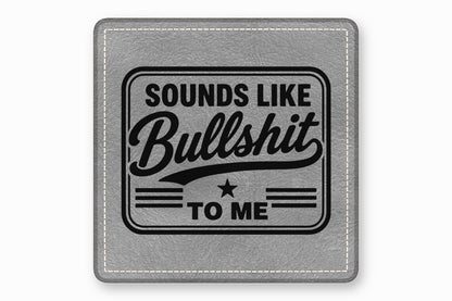 A gray square leather patch with white stitched border features black text reading Sounds Like Bullshit To Me.