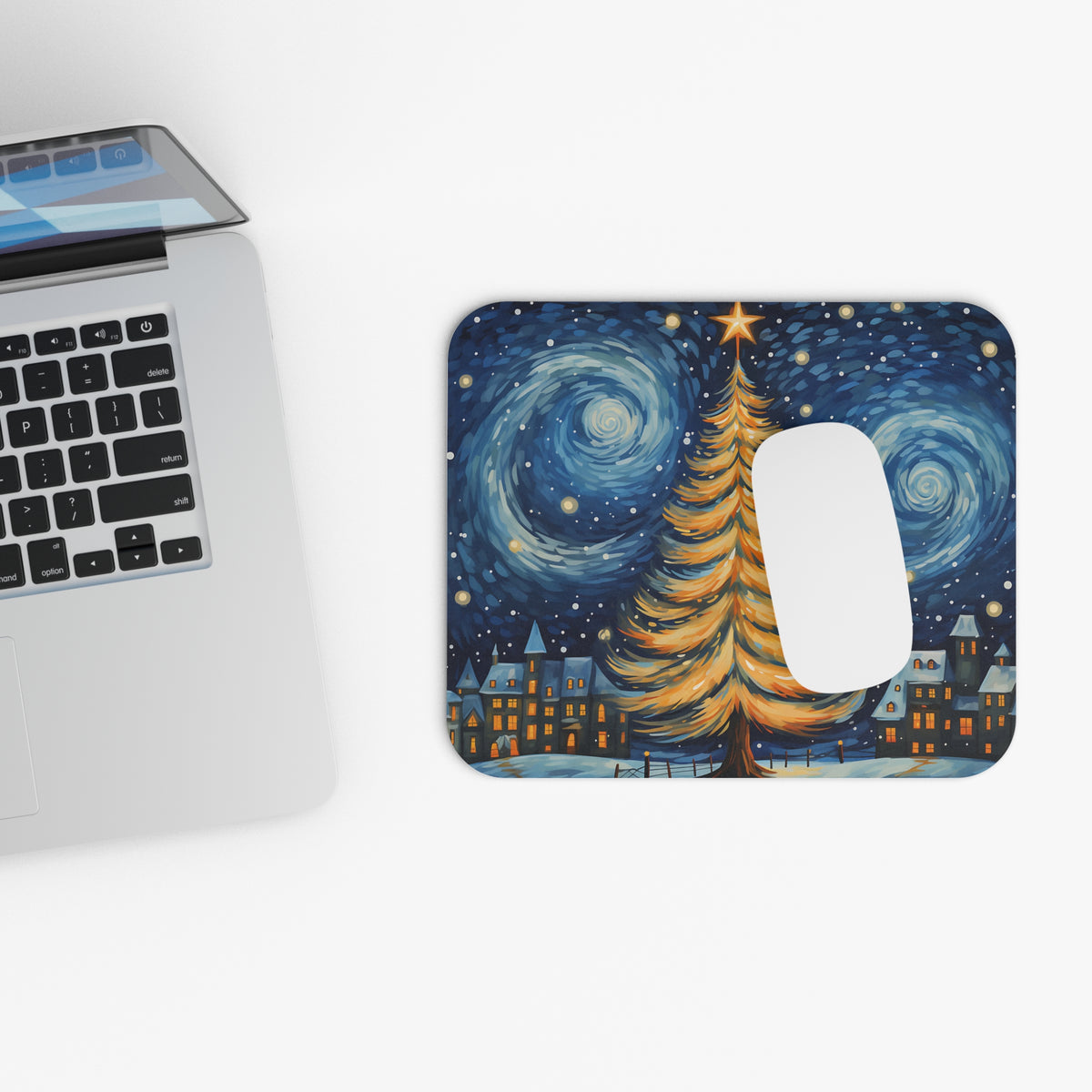 Mousepad with a starry night scene featuring a lit Christmas tree and village.