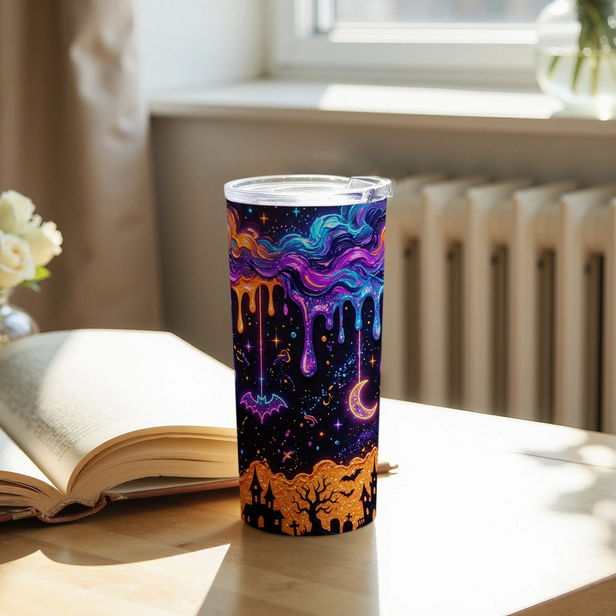 Tumbler with neon Halloween design featuring dripping colors, moon, bat, and spooky town.
