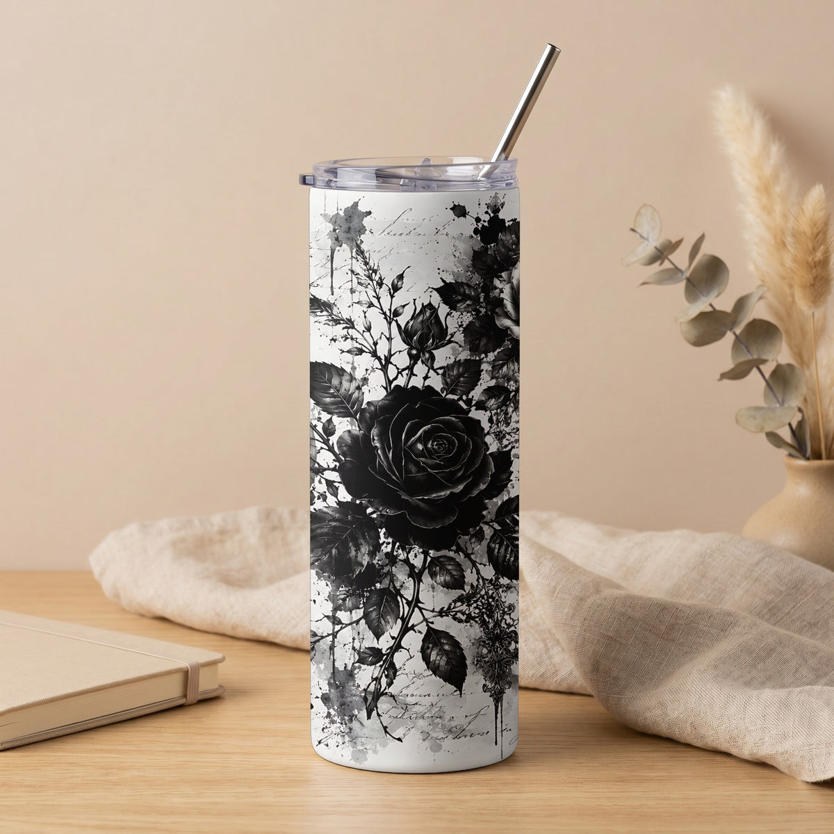 White tumbler with black gothic rose design and metal straw.