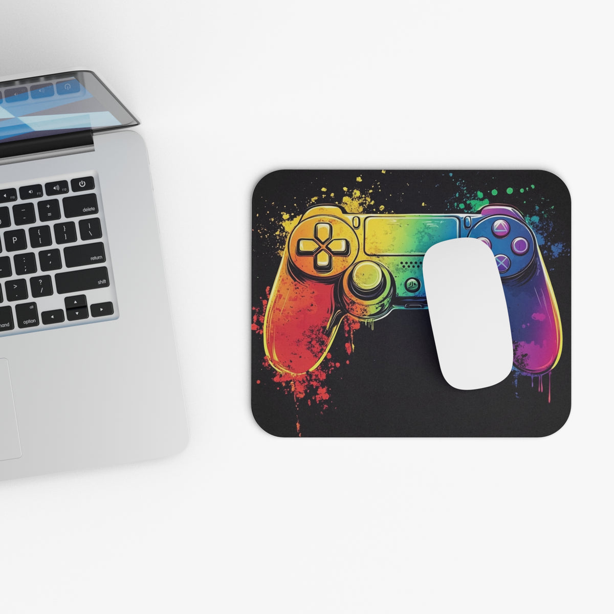 Mousepad featuring a rainbow-colored video game controller with paint splatter.