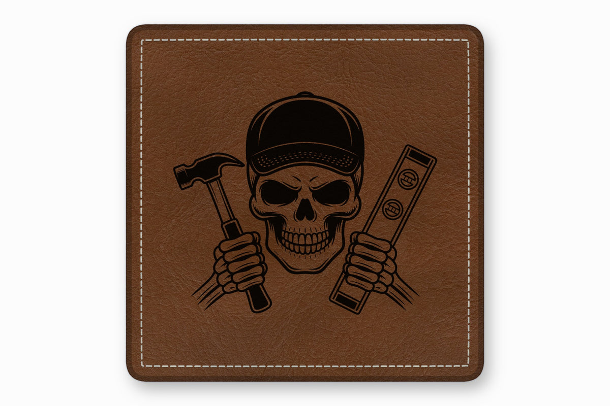 Brown leather square patch featuring a black laser-engraved skull wearing a cap and holding a hammer and level.