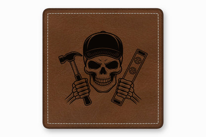 Brown leather square patch featuring a black laser-engraved skull wearing a cap and holding a hammer and level.