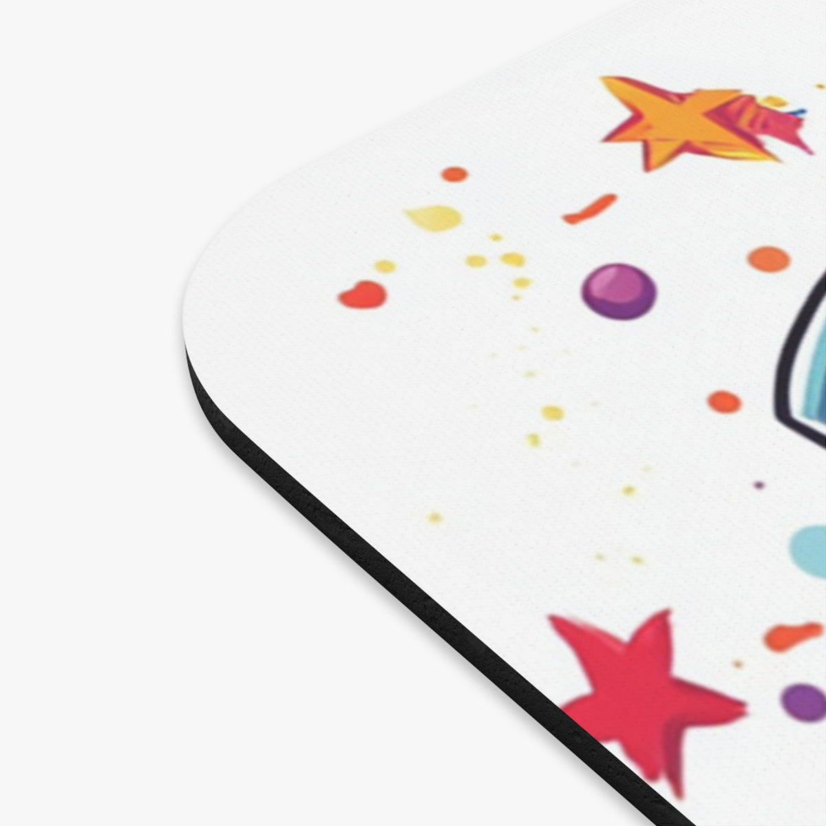 Mousepad with colorful stars, dots, and a partial unicorn design.