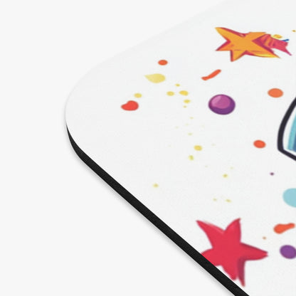 Mousepad with colorful stars, dots, and a partial unicorn design.