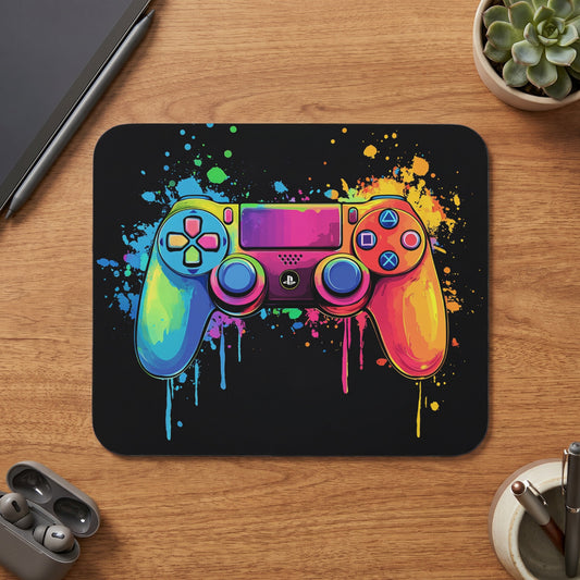 Colorful dripping paint video game controller on a black mousepad.