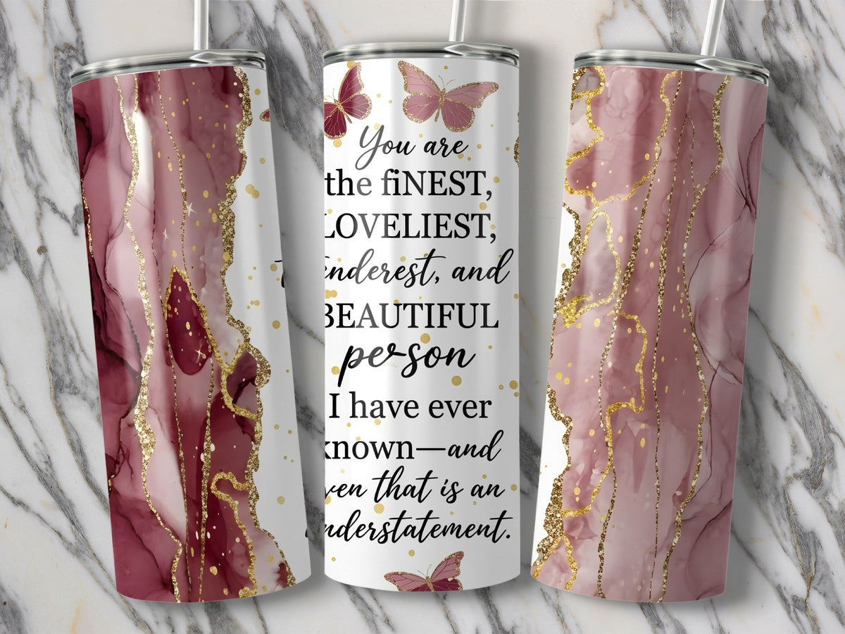 Tumbler with pink marble design, gold accents, butterflies, and text about a beautiful person.