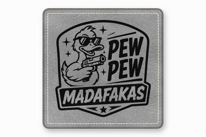 A grey leather square patch featuring a black graphic of a duck wearing sunglasses and holding a handgun, alongside the text Pew Pew Madafakas.