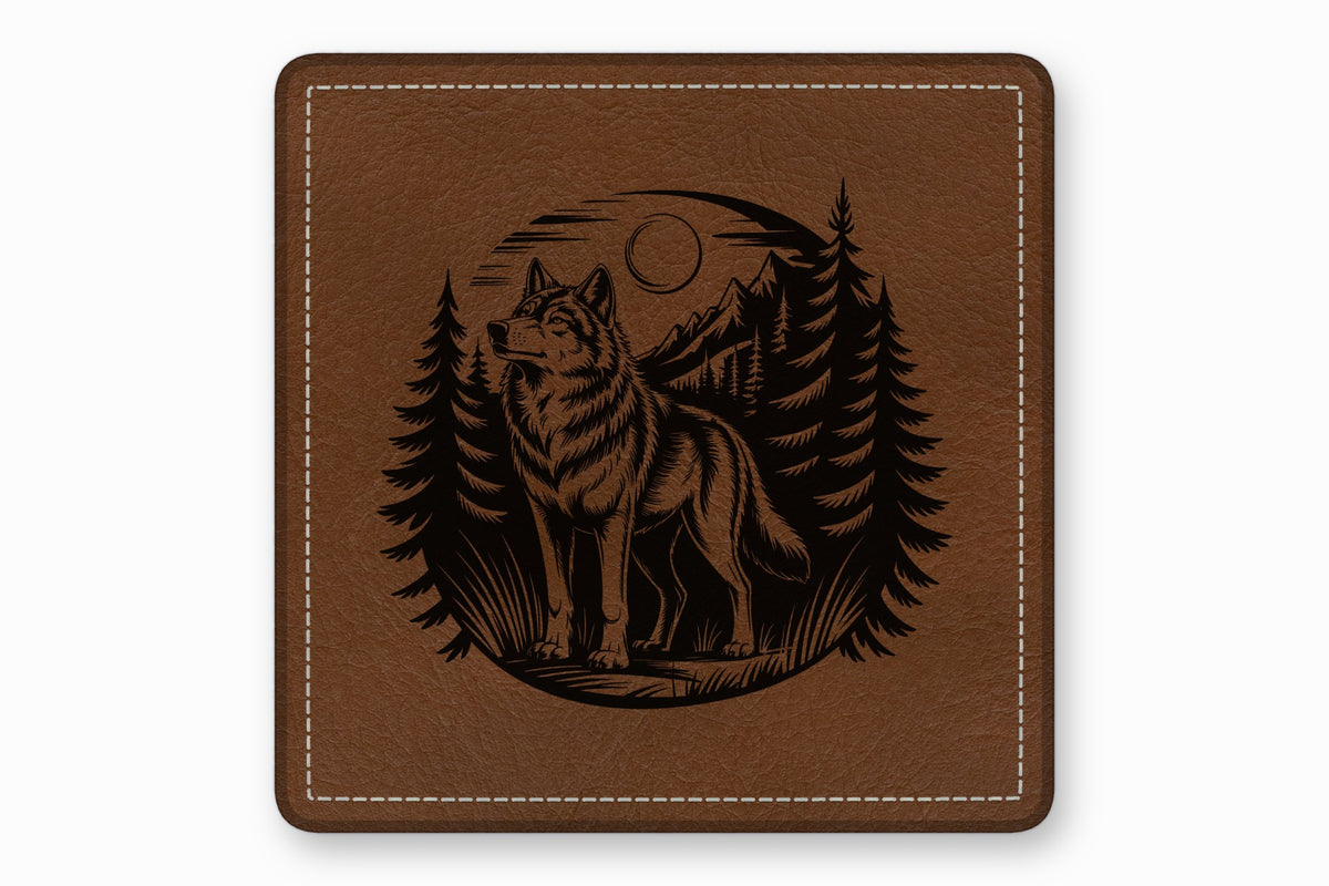 Square brown leather coaster featuring an engraved illustration of a wolf in a forest.