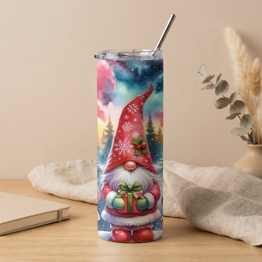 Tumbler with a watercolor Christmas gnome holding a gift and a starry night background.
