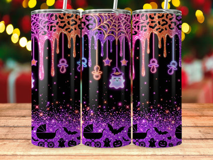 Three tumblers with dripping glitter, Halloween, and baby themes on a wooden table.