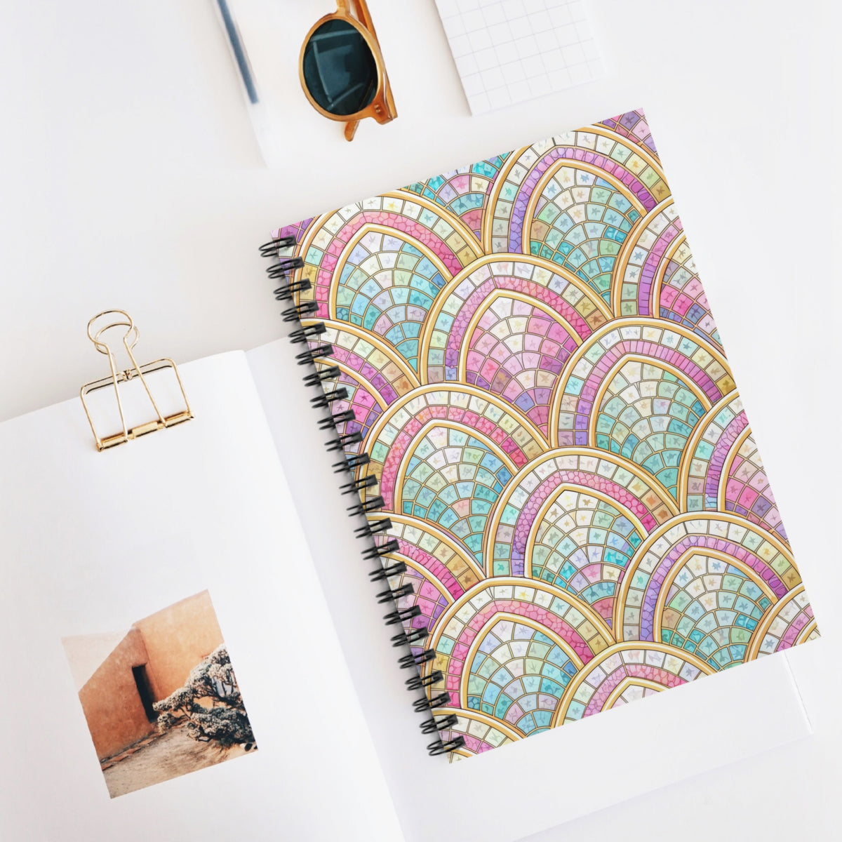 Spiral notebook with a stained glass fan pattern in pastel colors.