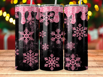 Three black tumblers with pink glitter drips and snowflakes on a wooden surface.