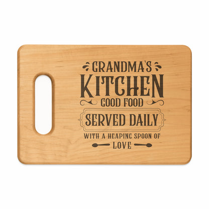 Wooden cutting board with "Grandma's Kitchen Good Food Served Daily" engraved text.