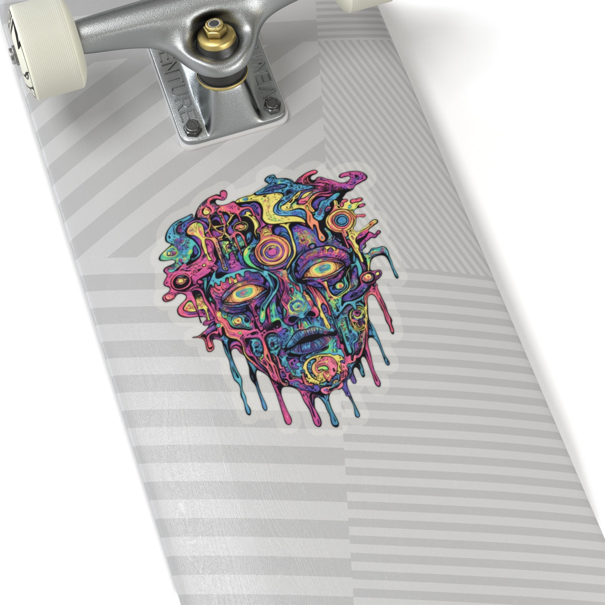 Colorful abstract melting face sticker on a light gray striped skateboard deck.