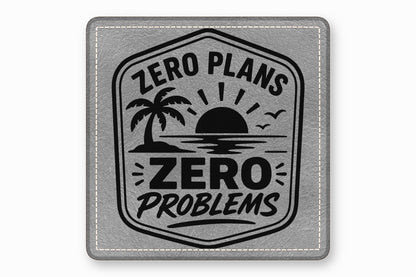 Square grey leatherette patch with stitched border, featuring a tropical sunset design and the text ZERO PLANS ZERO PROBLEMS.