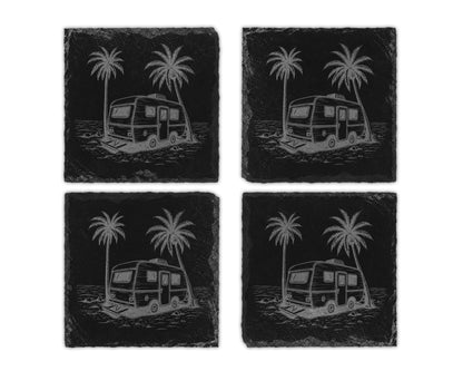 Four black slate coasters etched with a vintage trailer and palm trees on a beach.