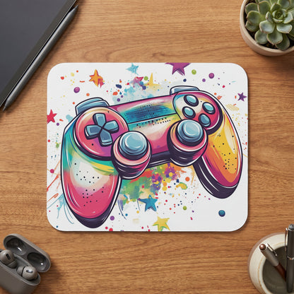 Colorful watercolor gaming controller with stars and paint splatters on a mousepad.