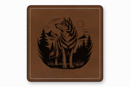 Square brown leather coaster with white stitched border and engraved design of a wolf in a forest.