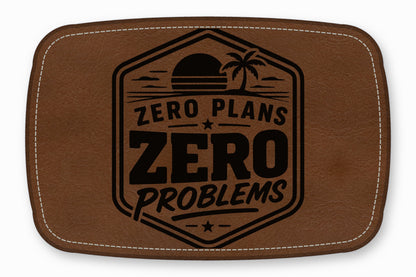 Brown rectangular leather patch with rounded corners, white stitching, and a black design featuring a sunset, palm tree, and the text ZERO PLANS ZERO PROBLEMS.