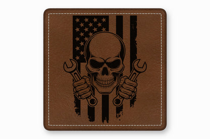 Brown leather patch with rounded corners featuring a skull holding two wrenches over an American flag design.