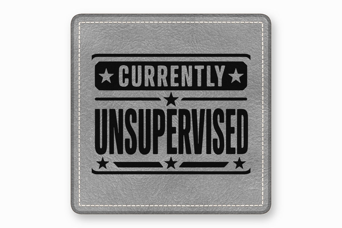 Grey leather patch with white stitched border and black text reading Currently Unsupervised surrounded by stars.