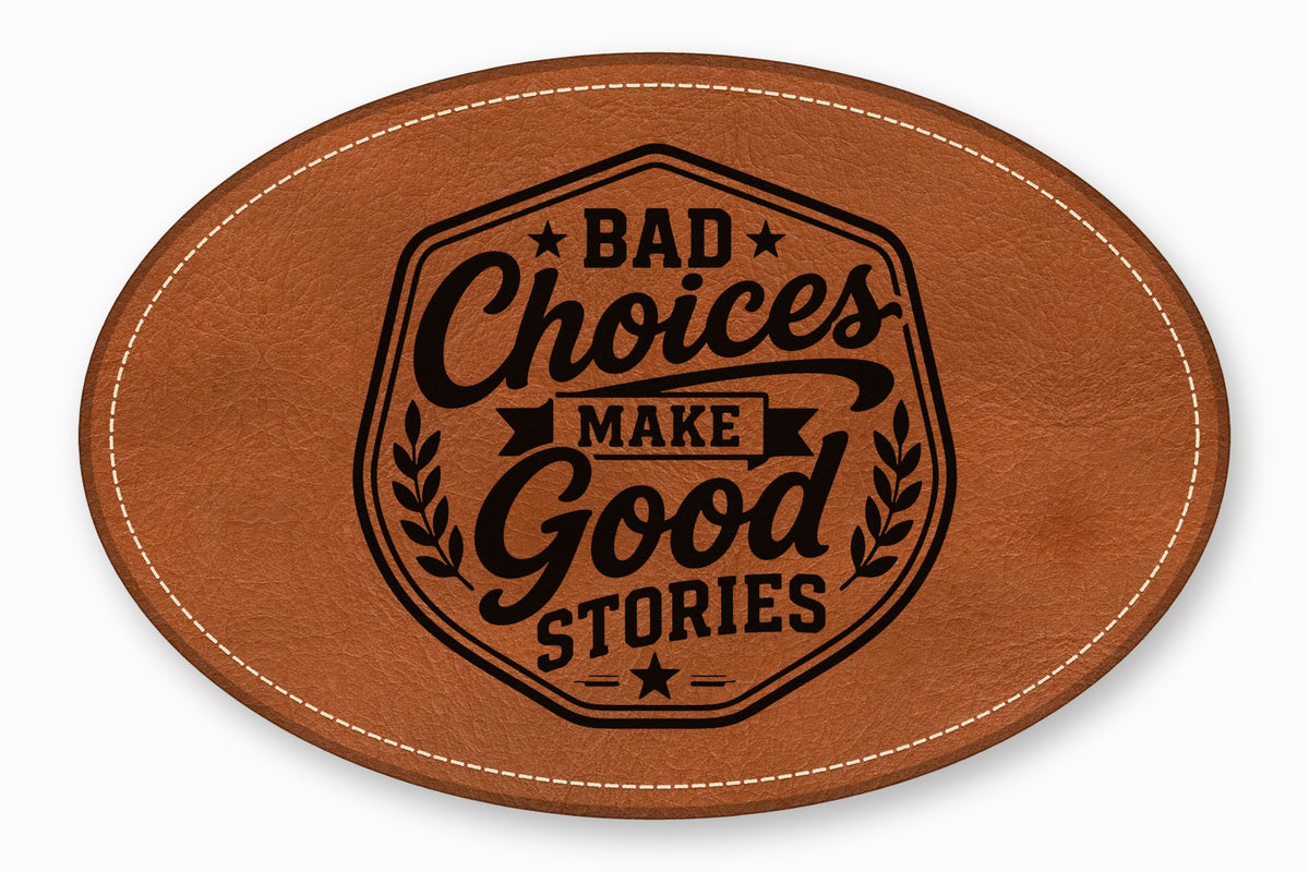 Oval brown leather patch with white stitched border and the engraved text Bad Choices Make Good Stories.