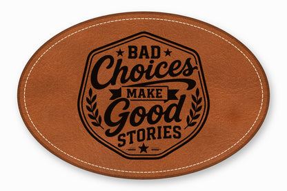 Oval brown leather patch with white stitched border and the engraved text Bad Choices Make Good Stories.