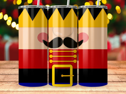 Three nutcracker tumblers with crowns and festive backgrounds.