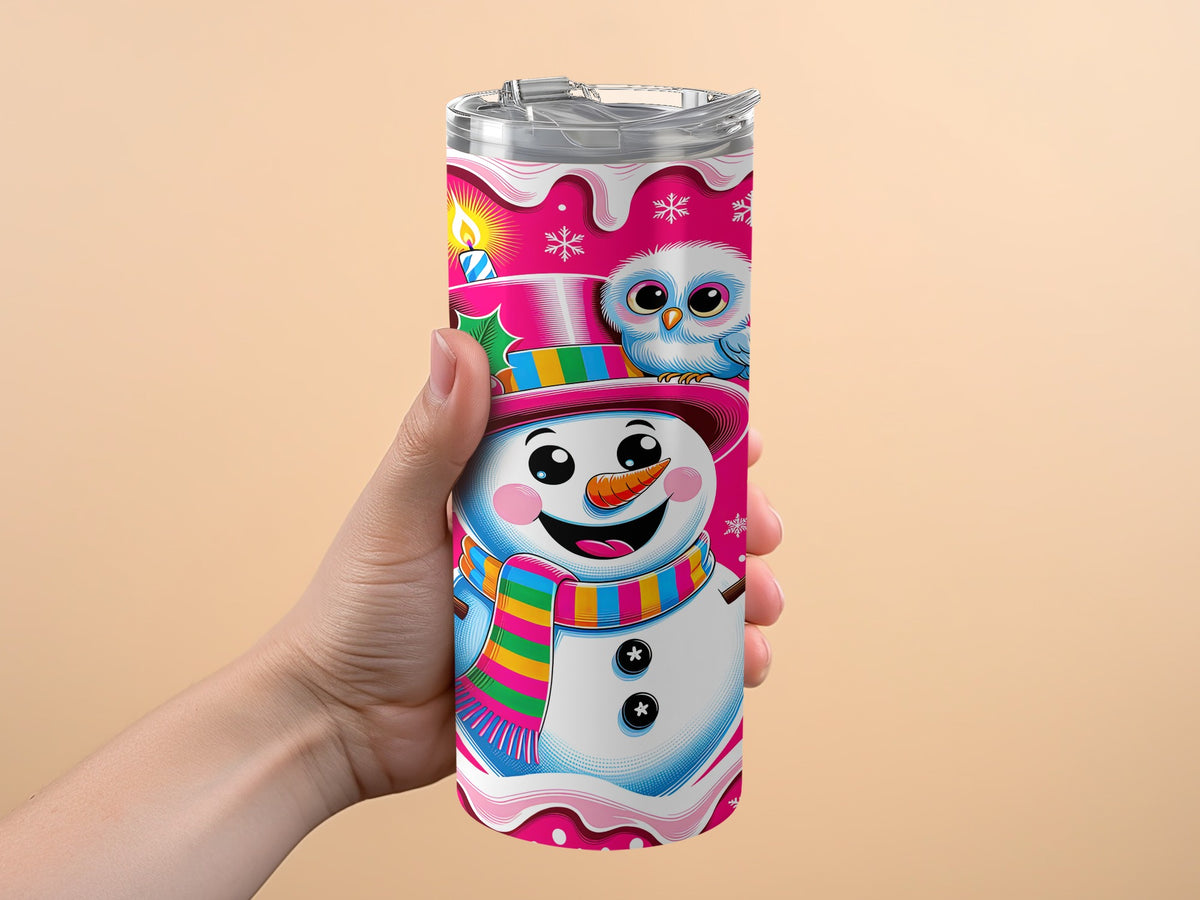 Tumbler with a happy snowman, owl, candle, and snowflakes on a pink background.