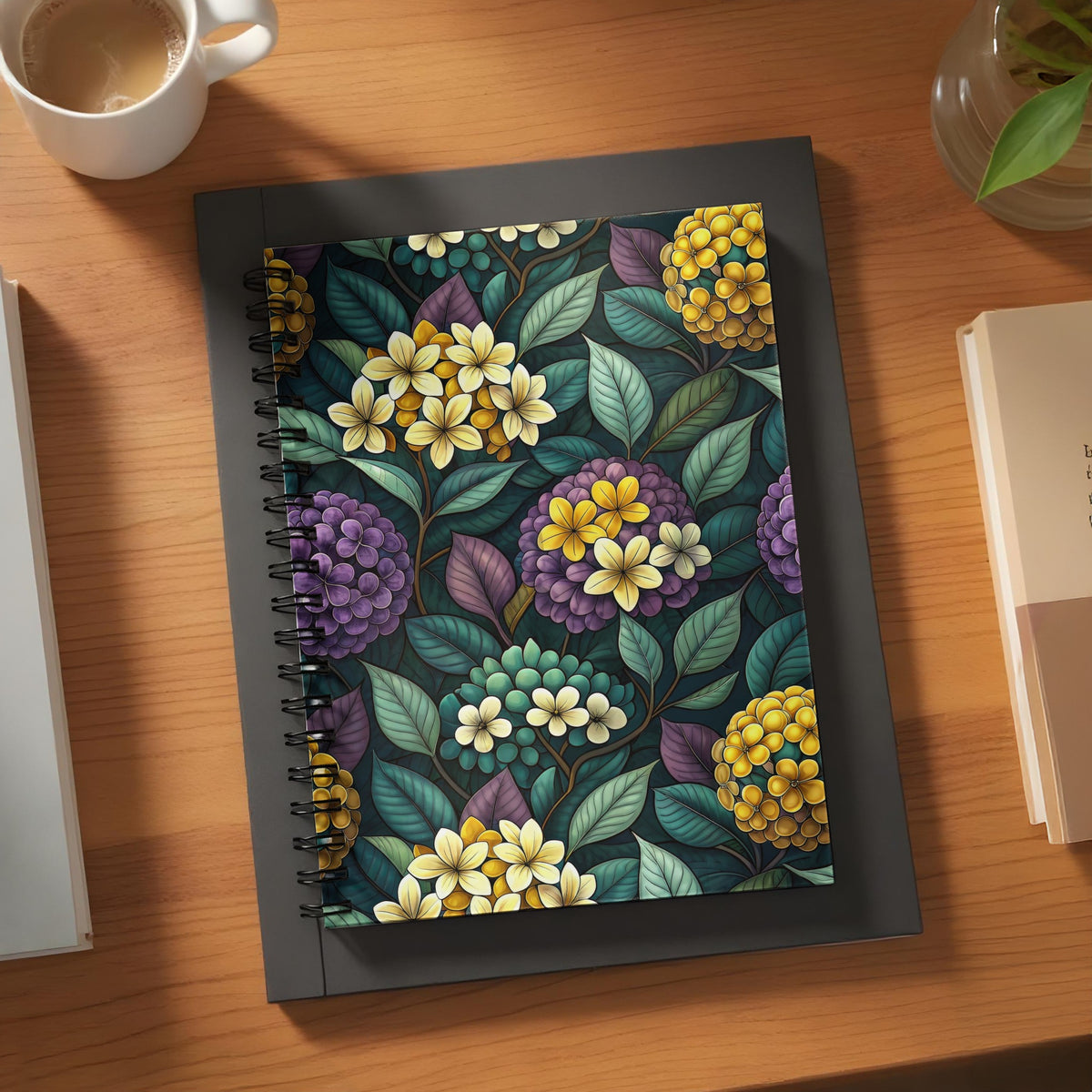 Spiral-bound notebook with a dark floral pattern featuring yellow and purple flowers.