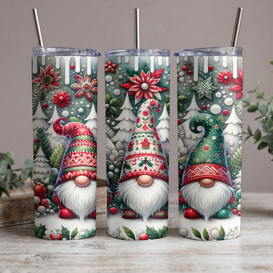 Three tumblers with festive gnome and winter forest designs and metal straws.