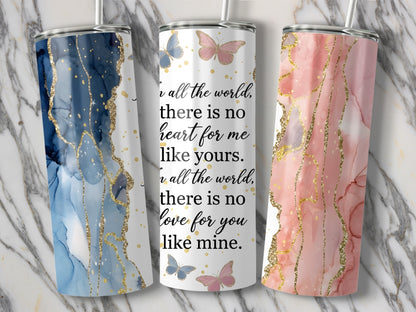 Three tumblers with abstract marbled designs and gold glitter accents.