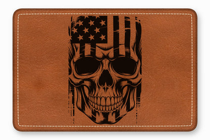 Brown leather patch featuring a black engraved skull overlaid with an American flag design.