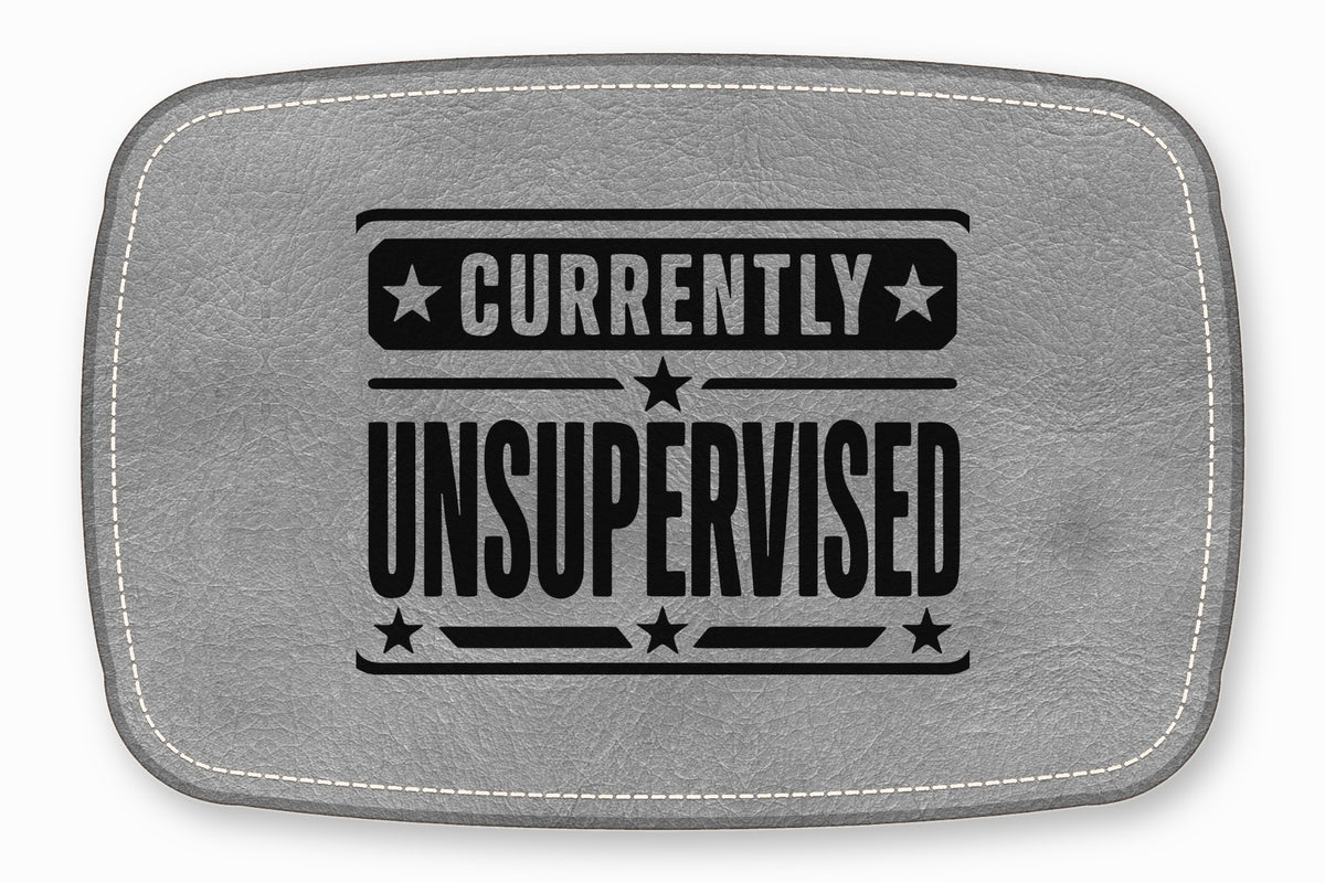 A gray leather patch with white stitched borders features the black text CURRENTLY UNSUPERVISED and stars.
